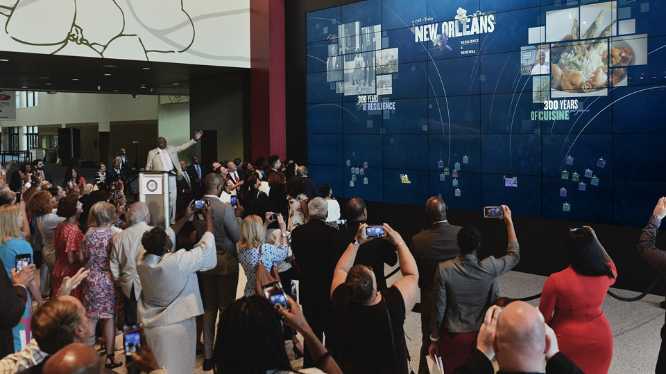 Crowd gathered in front of the video wall at the unveiling