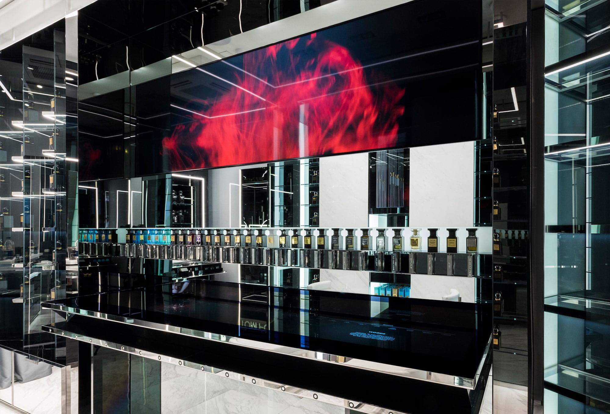 Mirrored fragrance counter Mirrored fragrance counter with a red ink bloom playing on the screen