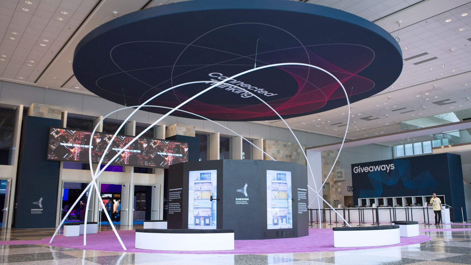 Samsung Connected Living installation in the conference lobby, with a ring canopy and curved light paths
